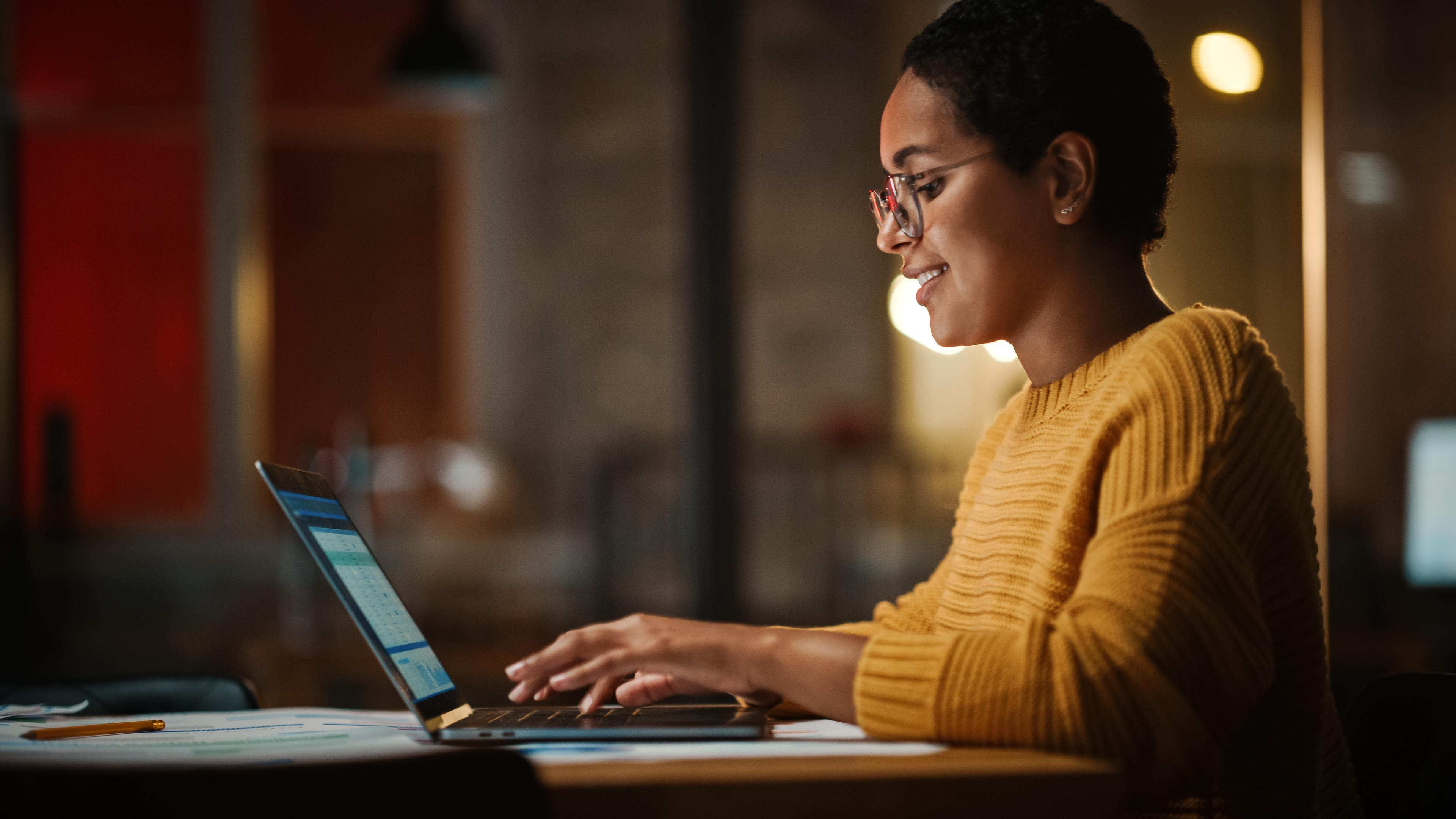 woman working at laptop at night