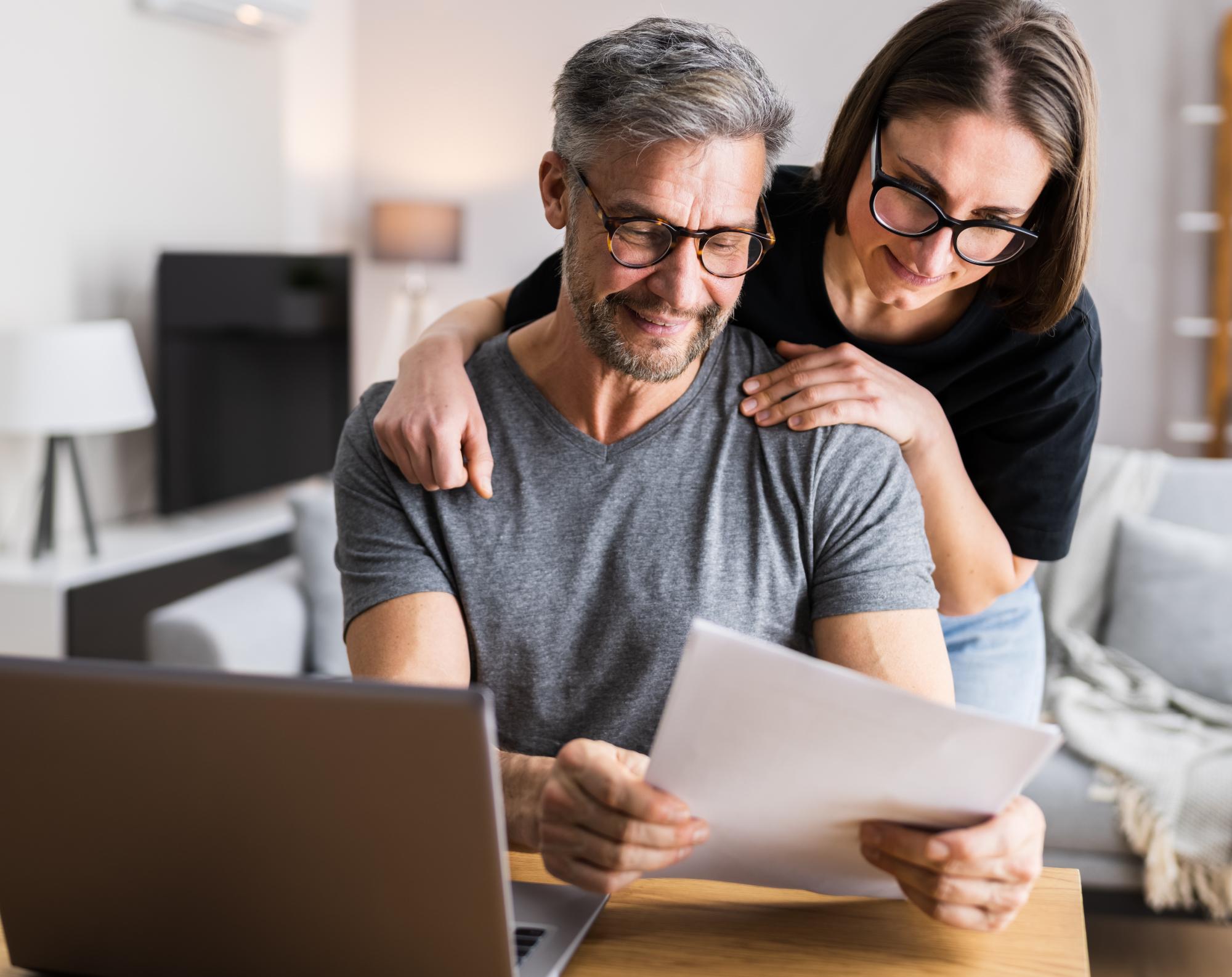 man and woman couple reviewing documents at a desk