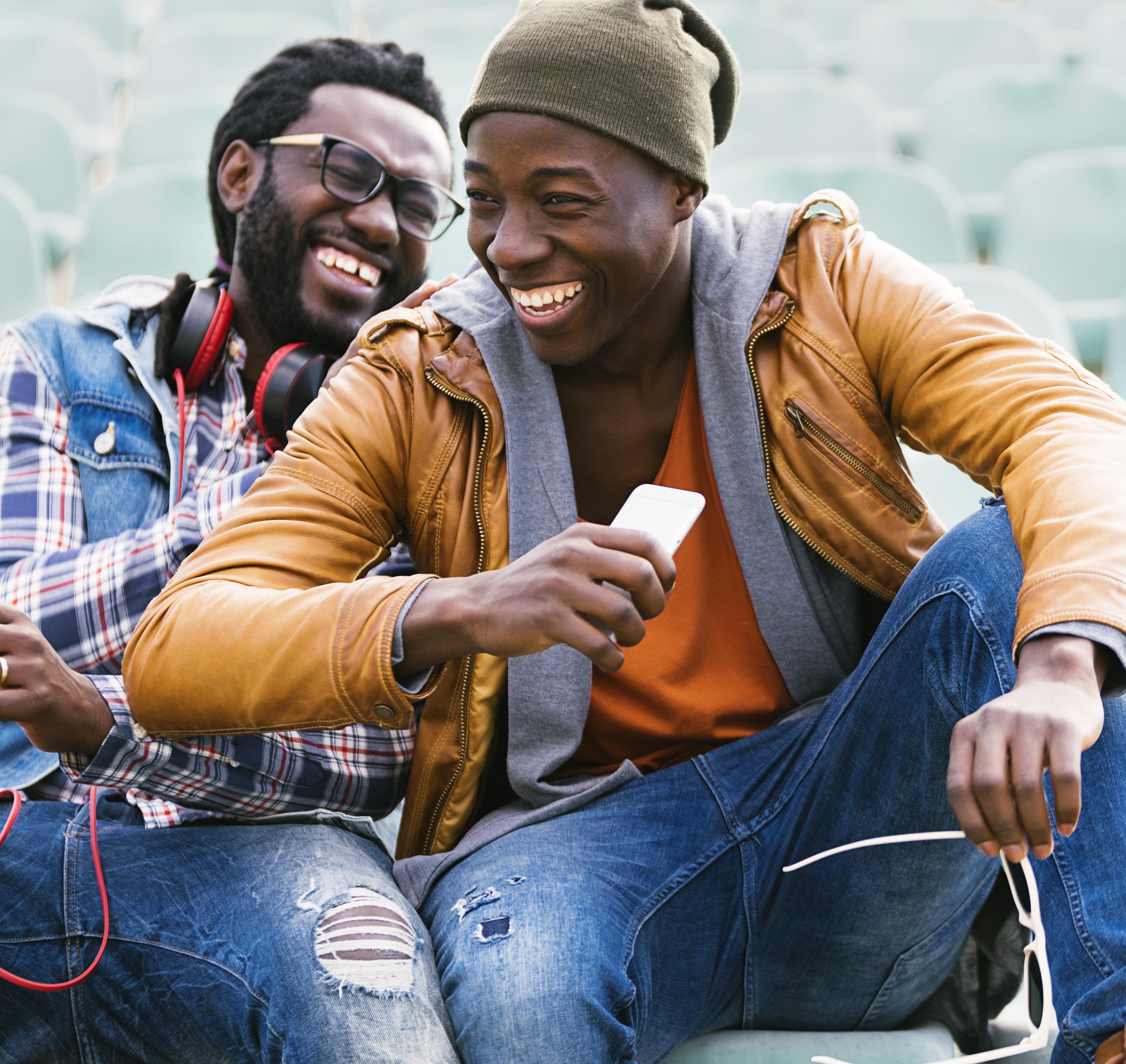 Two male friends laughing.