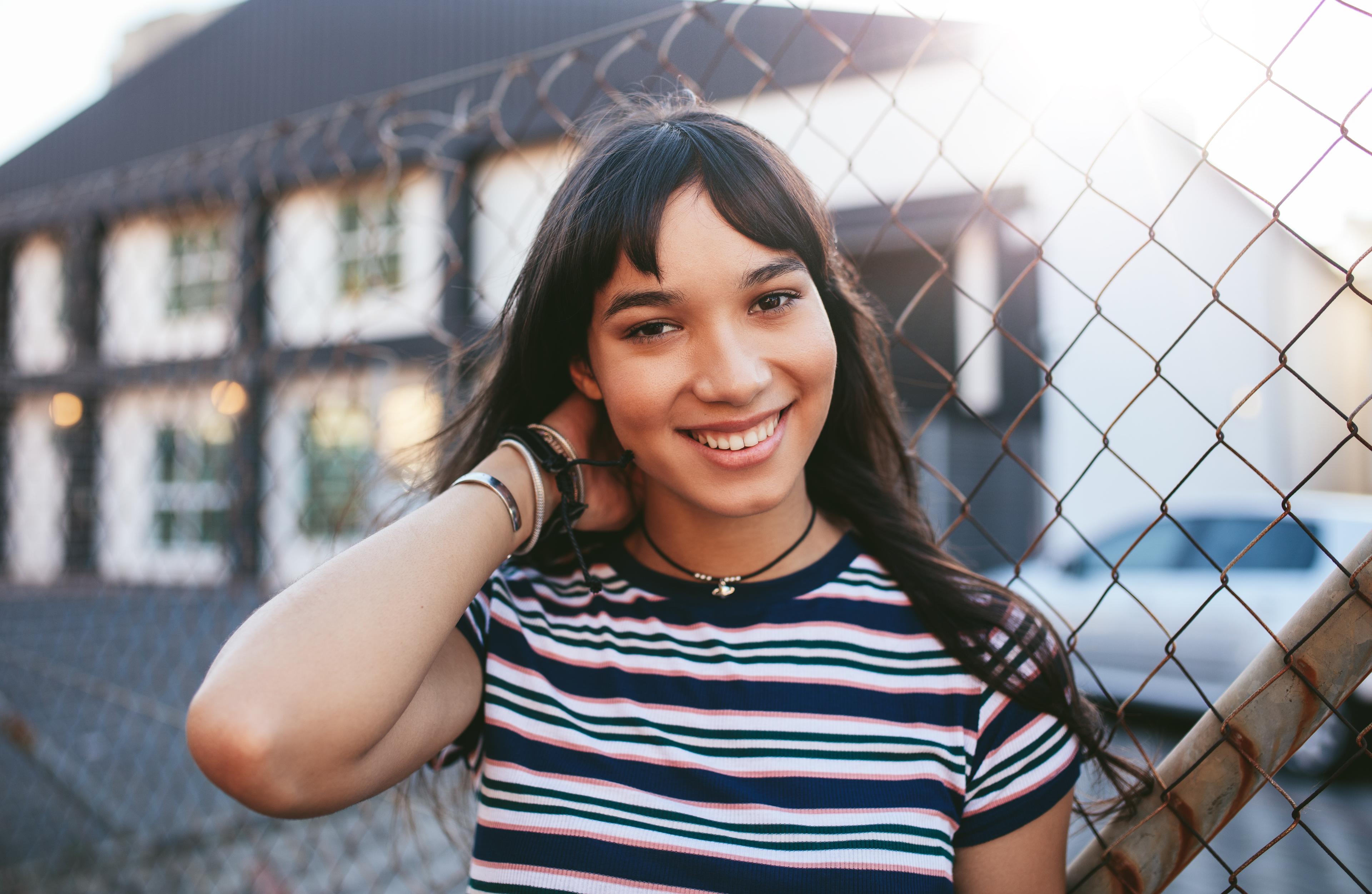 woman smiling by fence