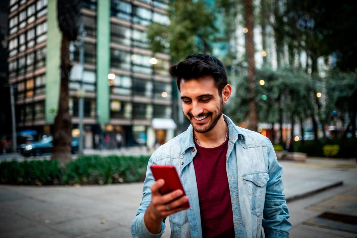 smiling man using his phone