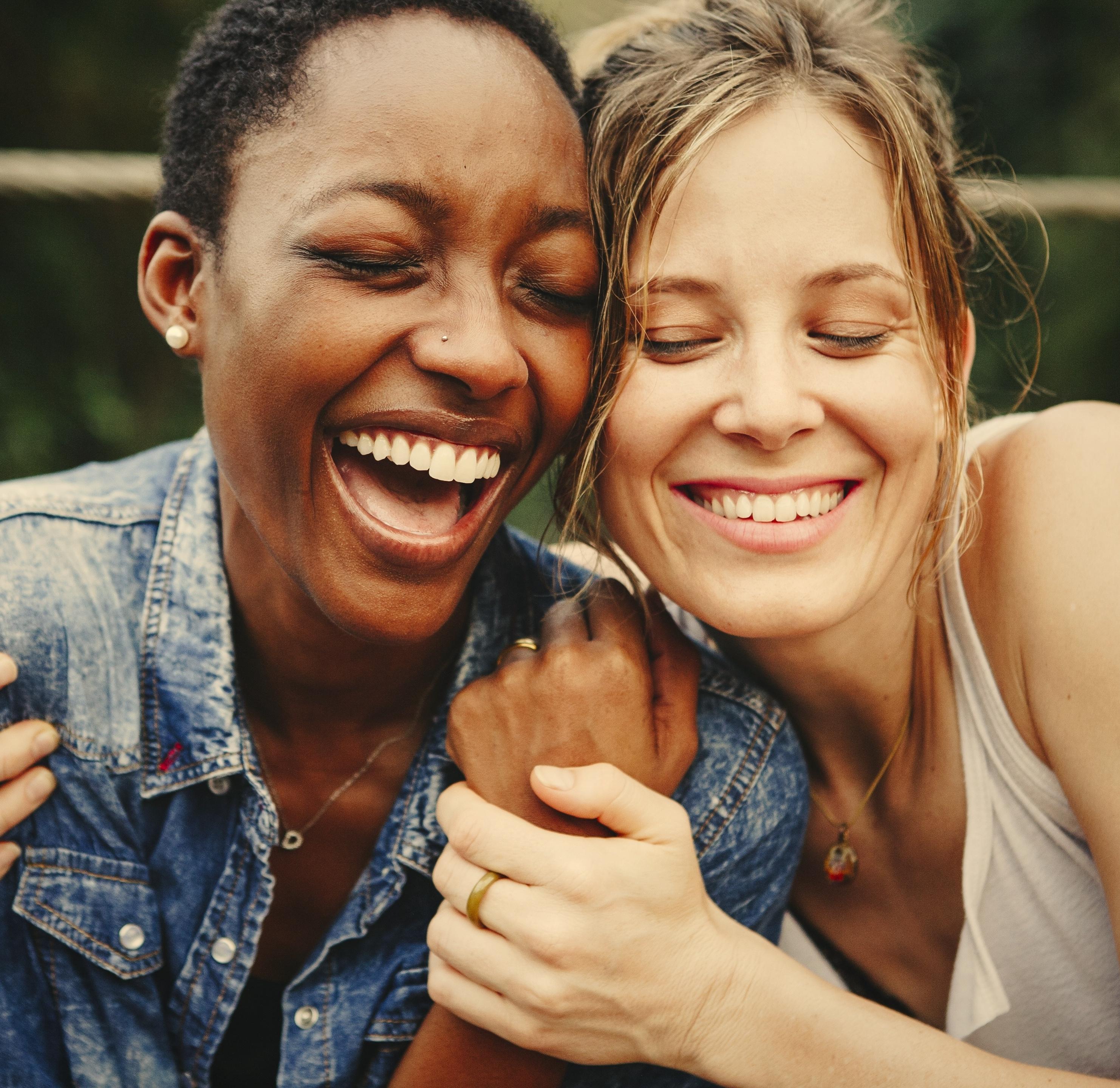 two ladies hugging and laughing