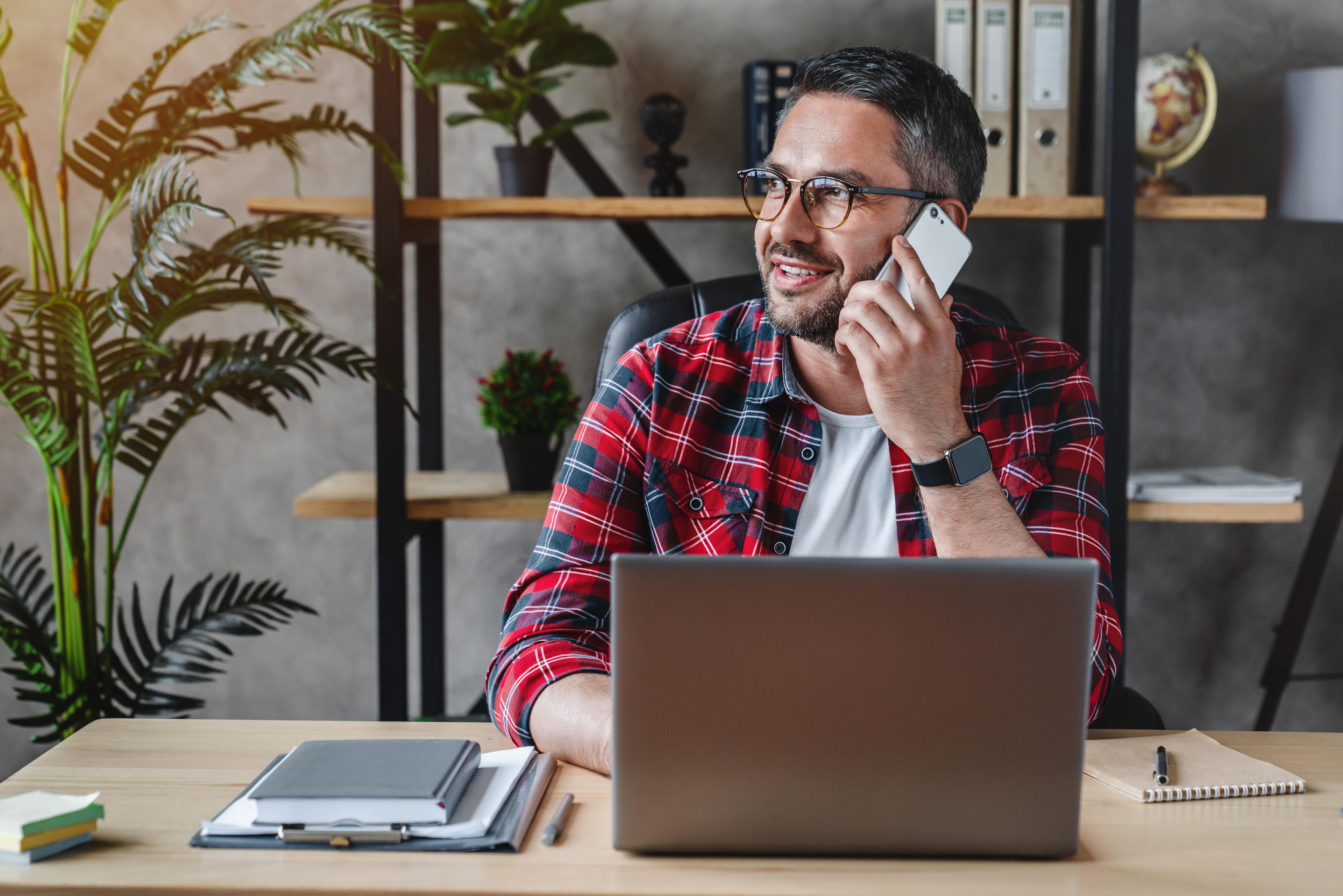 Self employed man with glasses on a laptop